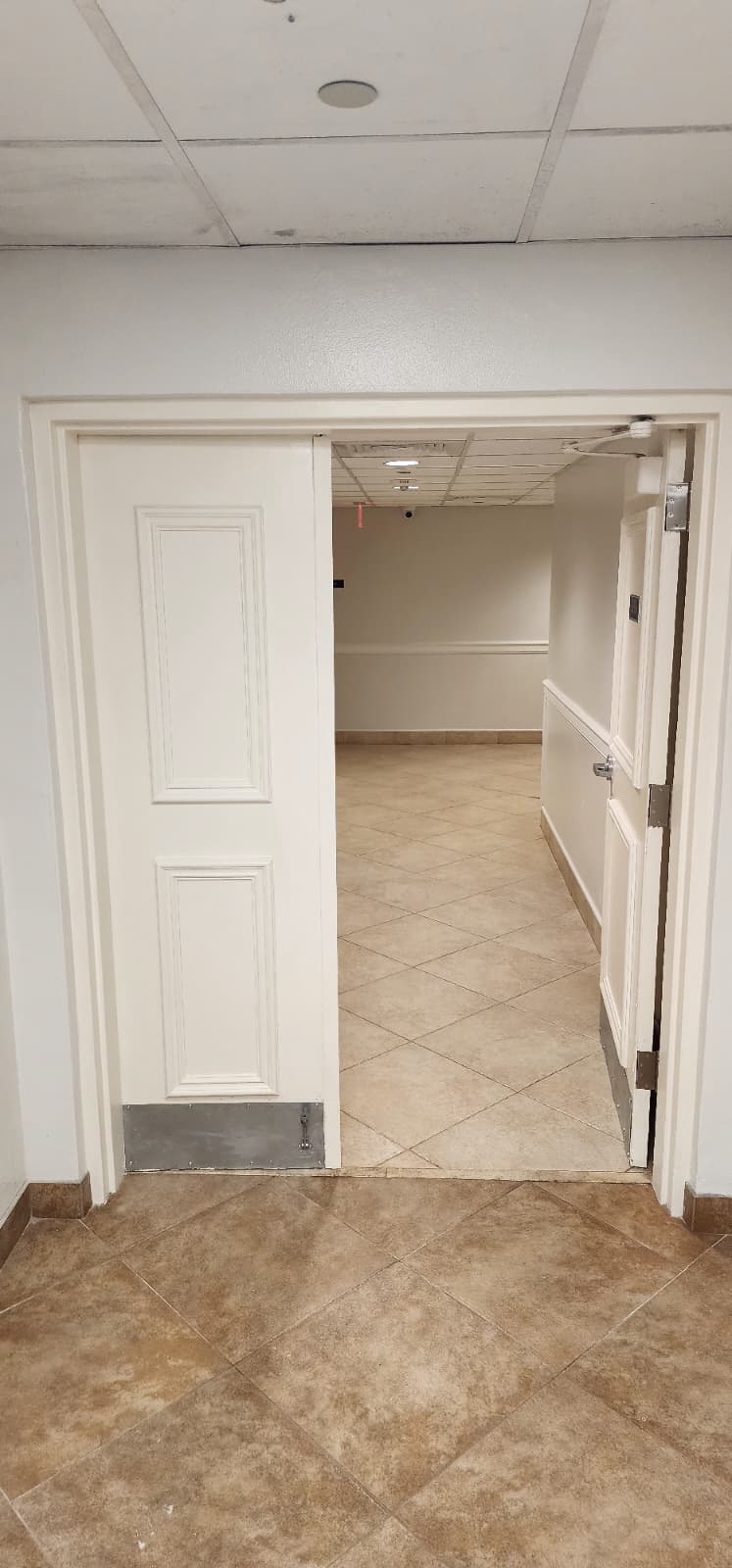 Commercial double doors open after hinge and alignment work