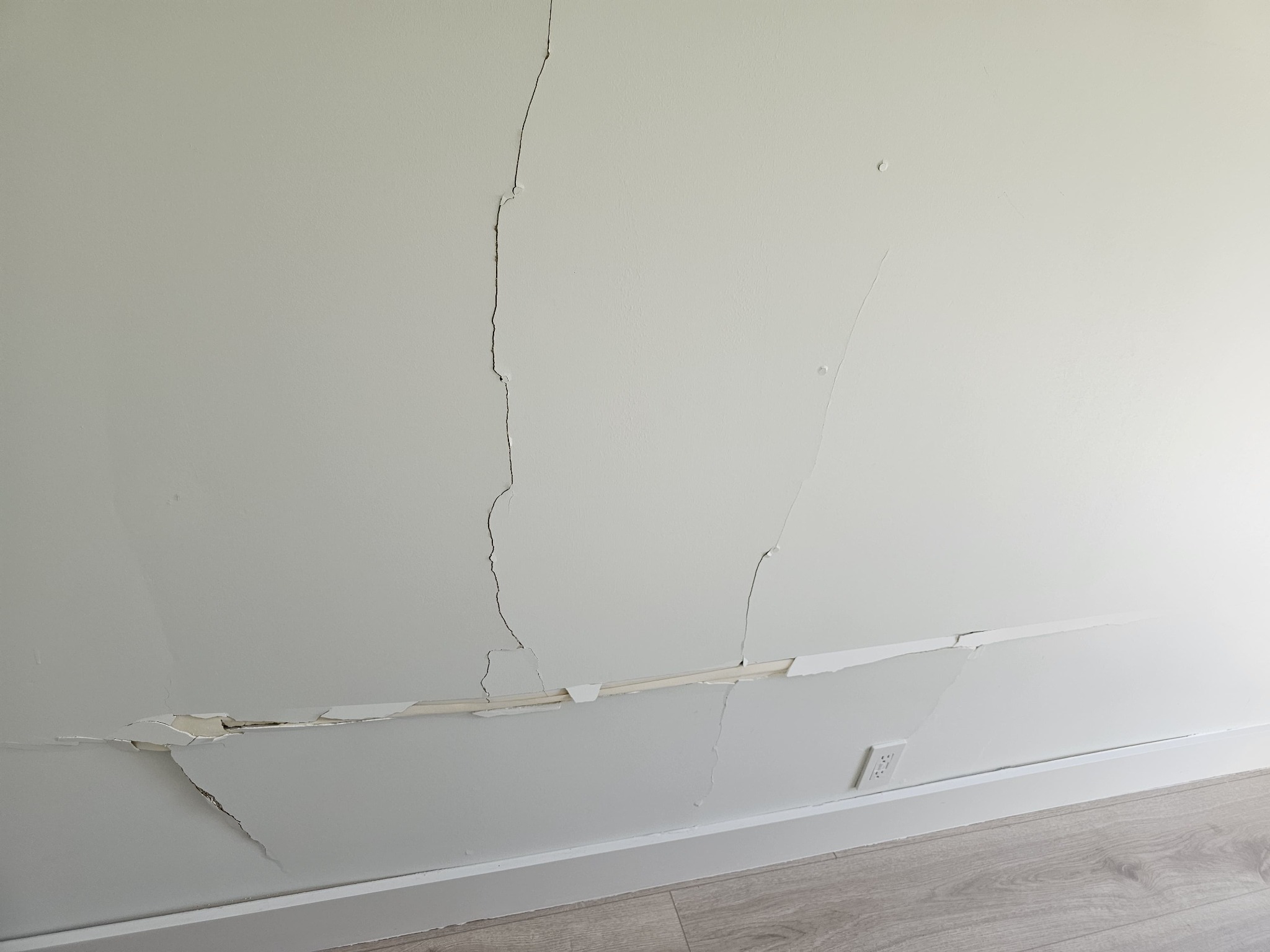 Extended drywall cracking caused by the garage wall impact