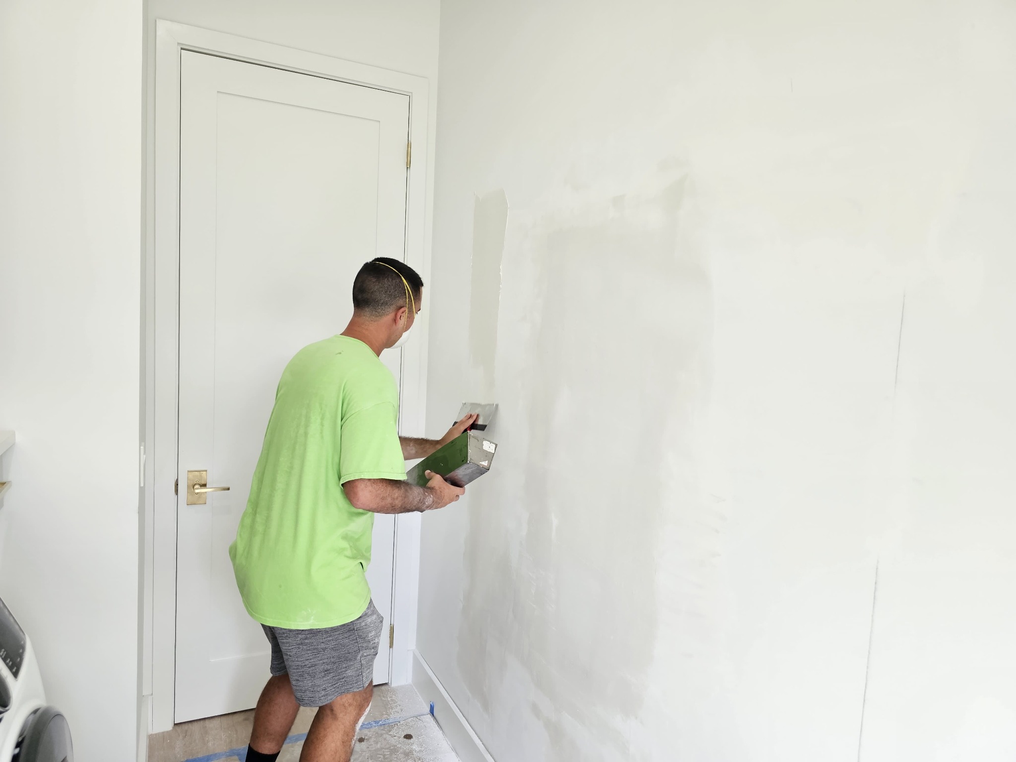 Drywall finishing work in progress on the interior side
