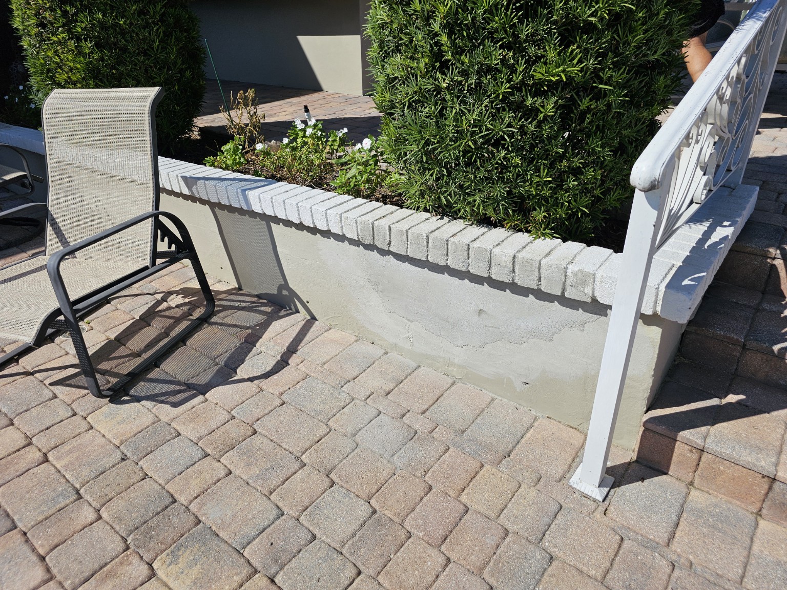 Repaired low stucco wall beside the pool deck