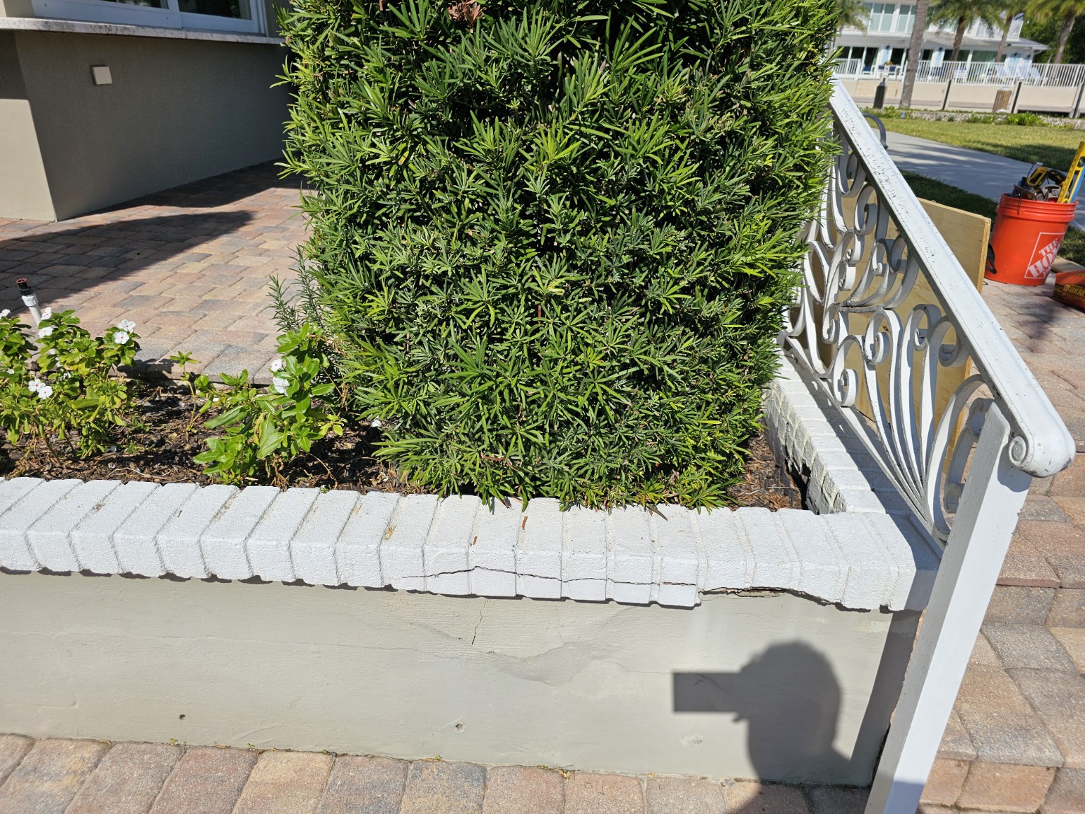 Long cracking across the poolside garden wall before repair