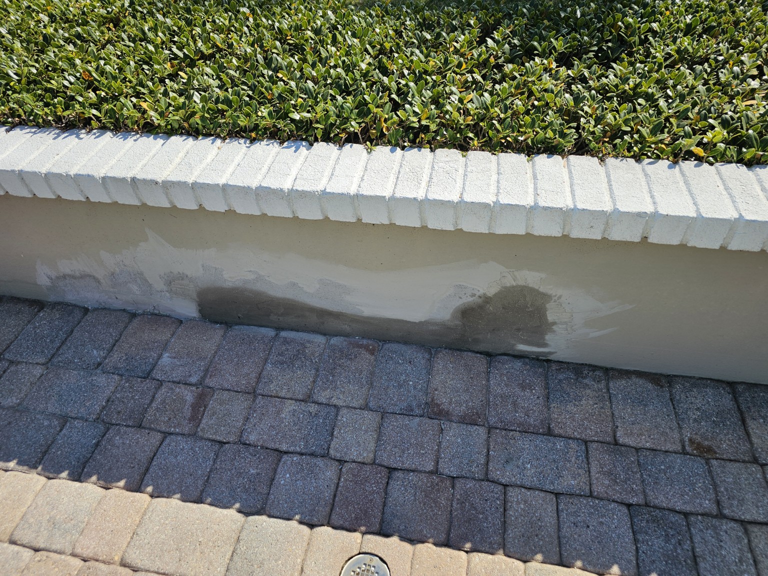 Localized stucco patches along the lower garden wall